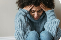Young person sitting thoughtfully